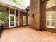 A spacious brick patio is attached to the brick exterior of the home and enclosed porch at 5816 Valley Stream Trl, Waxhaw, NC 28173