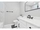 White bathroom features a large mirror, new tiling and modern fixtures at 5953 Prescott Ct # 3105, Charlotte, NC 28269