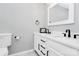 Bright bathroom with modern white cabinets, white sinks, and matte black fixtures at 5953 Prescott Ct # 3105, Charlotte, NC 28269