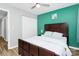 Cozy bedroom with a ceiling fan, closet, and bright accent wall at 5953 Prescott Ct # 3105, Charlotte, NC 28269