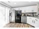 Well-lit kitchen features stainless steel appliances, ample storage and white cabinets at 5953 Prescott Ct # 3105, Charlotte, NC 28269