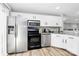 Modern kitchen with stainless steel appliances, granite countertops, and ample cabinet space at 5953 Prescott Ct # 3105, Charlotte, NC 28269