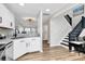 Kitchen with white cabinets and stainless appliances provides access to living and stair areas at 5953 Prescott Ct # 3105, Charlotte, NC 28269