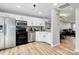 Modern kitchen with stainless appliances, white cabinets, and open access to a living area at 5953 Prescott Ct # 3105, Charlotte, NC 28269
