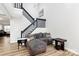 Stylish living room showcasing wood floors, a modern staircase, and a comfortable seating area at 5953 Prescott Ct # 3105, Charlotte, NC 28269
