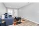 Inviting living room featuring a stylish gray sofa, patterned rug, and ample natural light from the front window at 5953 Prescott Ct # 3105, Charlotte, NC 28269