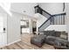 Bright open-concept living area featuring new flooring, neutral paint, and a staircase at 5953 Prescott Ct # 3105, Charlotte, NC 28269