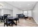 Spacious living area with view of a dining area, gray sofa, hardwood floors, and good natural light at 5953 Prescott Ct # 3105, Charlotte, NC 28269
