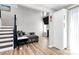 Sunlit living space with wood floors, a cozy seating area, and access to other home areas at 5953 Prescott Ct # 3105, Charlotte, NC 28269
