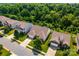 An aerial view of a house with well-manicured lawn, tree-lined street, and landscaping at 6038 Durango Way, Denver, NC 28037