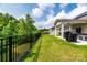 A lush backyard with a wrought iron fence and covered patio with a grill, perfect for entertaining at 6038 Durango Way, Denver, NC 28037