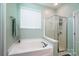 Bathroom boasts soaking tub under window and separate glass enclosed shower at 6038 Durango Way, Denver, NC 28037