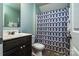 Bathroom showcases vanity and toilet with patterned shower curtain at 6038 Durango Way, Denver, NC 28037