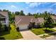 A picturesque home with lush green lawn, mature tree, and a two-car garage at 6038 Durango Way, Denver, NC 28037
