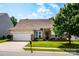 Charming single-story home with a well-manicured lawn, brick accents, and a two-car garage on a sunny day at 6038 Durango Way, Denver, NC 28037