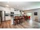 Bright open kitchen and living area, complete with stainless steel appliances, granite countertops, and seating at 6038 Durango Way, Denver, NC 28037