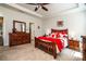 Comfortable main bedroom featuring tray ceilings, a large bed, and warm wood furnishings at 6038 Durango Way, Denver, NC 28037