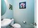 Fresh powder room showcasing a modern sink, toilet, and vibrant wall art at 6038 Durango Way, Denver, NC 28037