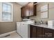 Well-equipped laundry room with washer, dryer, and ample cabinet space at 73 41St Nw Ave, Hickory, NC 28601