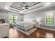 Bright main bedroom with tray ceiling, hardwood floors, and large windows at 73 41St Nw Ave, Hickory, NC 28601