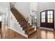 Grand foyer with staircase boasting wood treads, decorative iron spindles, and hardwood flooring at 73 41St Nw Ave, Hickory, NC 28601