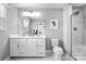 Elegant bathroom featuring double vanity, modern fixtures, and a glass-enclosed shower with a marble surround at 7335 Childress Dr, Concord, NC 28025