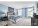 Nautical-themed bedroom with blue walls, carpet, and large windows creating a cheerful space at 7335 Childress Dr, Concord, NC 28025