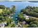 Aerial view of a waterfront community showcasing stunning homes, lush trees, and peaceful lake access at 7545 Rabbit Cir, Denver, NC 28037