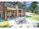 Back patio features brick pillars and outdoor seating, perfect for enjoying the backyard and upper screened deck at 7545 Rabbit Cir, Denver, NC 28037