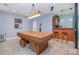 Basement features a billiards table and a bar with stools for a relaxed and entertaining atmosphere at 7545 Rabbit Cir, Denver, NC 28037
