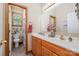 Bathroom features a double vanity, framed mirror, and natural light from a nearby window at 7545 Rabbit Cir, Denver, NC 28037