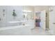 Bright bathroom with a glass shower, double vanity, and access to the bedroom at 7545 Rabbit Cir, Denver, NC 28037
