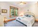 Bedroom with a large window and a ceiling fan offers natural light and comfort at 7545 Rabbit Cir, Denver, NC 28037