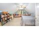 Comfortable carpeted bedroom featuring an accent wall, a ceiling fan, and a quaint sitting area at 7545 Rabbit Cir, Denver, NC 28037