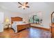 Bedroom with wood floors, a ceiling fan, and a large window at 7545 Rabbit Cir, Denver, NC 28037