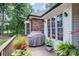 Wooden deck surrounded by lush greenery and flowers, features a grill, great for outdoor cooking at 7545 Rabbit Cir, Denver, NC 28037