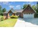 Charming brick home with a well-manicured lawn, a two-car garage, and a classic design at 7545 Rabbit Cir, Denver, NC 28037