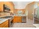 A well-appointed kitchen with stainless steel appliances, and travertine tile flooring at 7545 Rabbit Cir, Denver, NC 28037