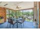 Inviting screened-in porch with a ceiling fan and outdoor seating offering peaceful lake views at 7545 Rabbit Cir, Denver, NC 28037