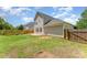 Spacious backyard with green grass, wood fence, and brick patio at 7642 Rolling Meadows Ln, Huntersville, NC 28078