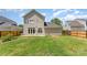 Large grassy backyard with wood fence, brick patio and landscaping at 7642 Rolling Meadows Ln, Huntersville, NC 28078
