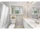 Bright bathroom with tub, shower, and window featuring a large mirror, a clean aesthetic at 7642 Rolling Meadows Ln, Huntersville, NC 28078