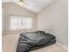 Spacious carpeted bedroom with a ceiling fan, vaulted ceilings, and large window at 7642 Rolling Meadows Ln, Huntersville, NC 28078