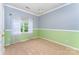 Cozy bedroom with large window, two-tone paint, offering a bright, blank canvas at 7642 Rolling Meadows Ln, Huntersville, NC 28078