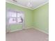 Bright bedroom with light green walls, plush carpet and a chandelier at 7642 Rolling Meadows Ln, Huntersville, NC 28078
