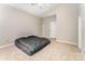 Bedroom with a large window, carpet, and neutral paint, offering a bright, blank canvas at 7642 Rolling Meadows Ln, Huntersville, NC 28078
