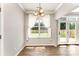 Bright dining area with wood floors, modern chandelier, and access to the backyard patio at 7642 Rolling Meadows Ln, Huntersville, NC 28078