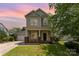 Charming two-story home with well-maintained landscaping and inviting front porch at 7642 Rolling Meadows Ln, Huntersville, NC 28078