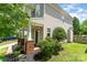 Side view of the home featuring the entrance, a well-kept lawn, and mature landscaping at 7642 Rolling Meadows Ln, Huntersville, NC 28078