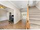 Inviting foyer with wood floors, staircase, and access to a bright office space at 7642 Rolling Meadows Ln, Huntersville, NC 28078